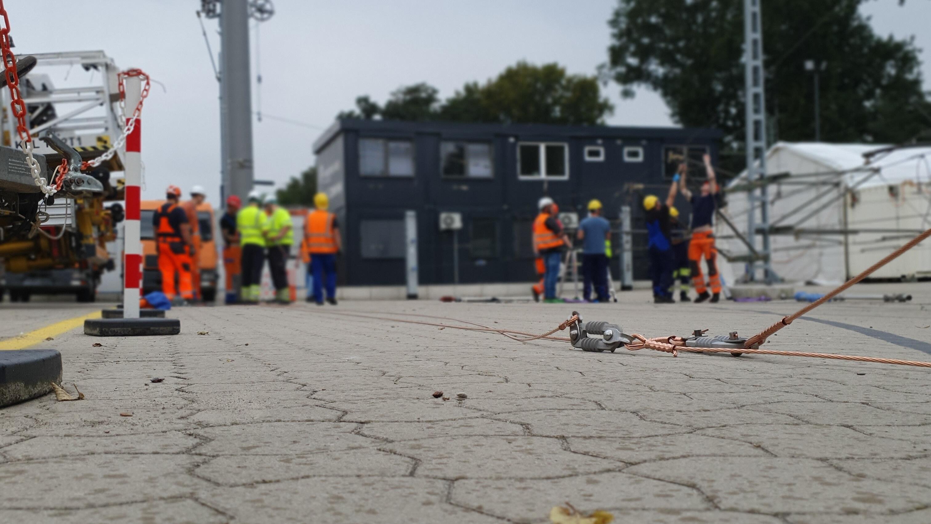 Lehrgangsteilnehmende bereiten Arbeiten an Oberleitungen vor.